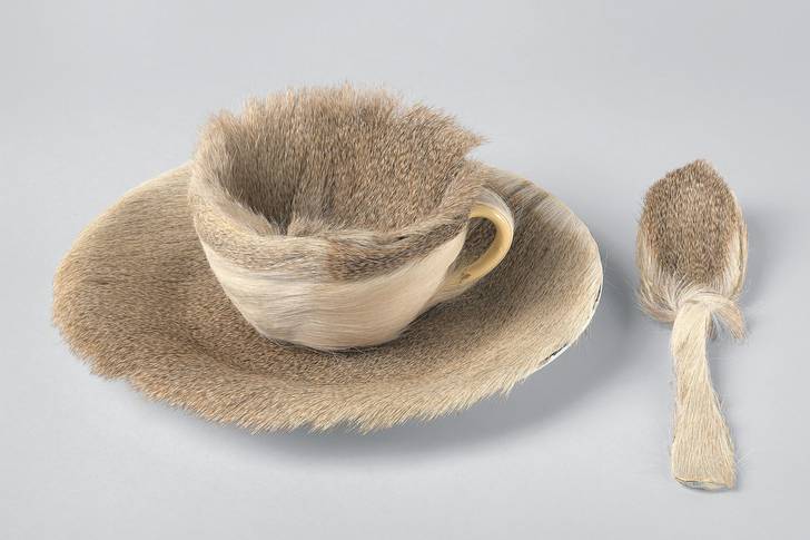A cup, saucer and spoon covered in fur.